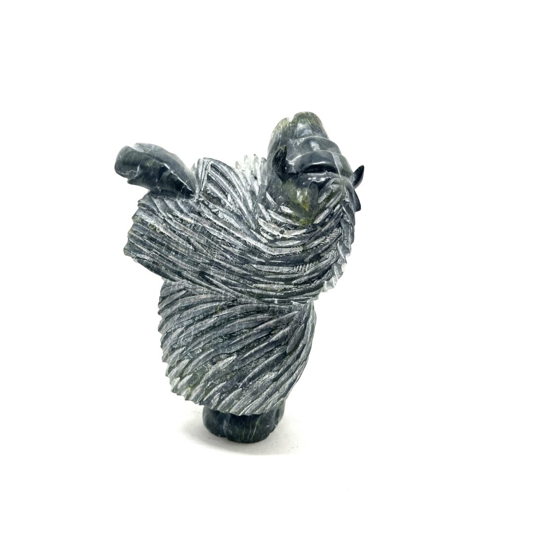 One original hand-carved sculpture by Inuit artist, Pits Qimirpik. One dancing musk ox carved out of serpentine.