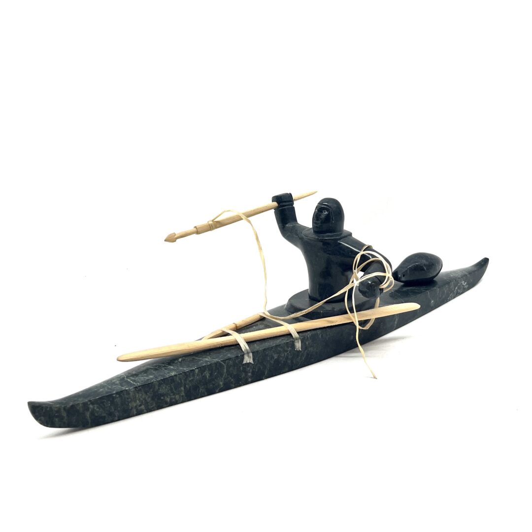 One original hand-carved sculpture by Inuit artist, Noah Jaw. One kayaker sculpture carved out of serpentine.
