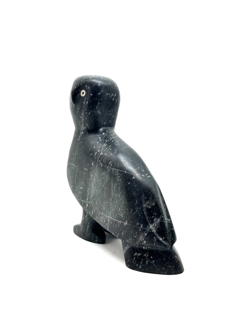 One original hand-carved sculpture by Inuit artist, Kupapik Ningeocheak. One owl sculpture carved out of basalt.