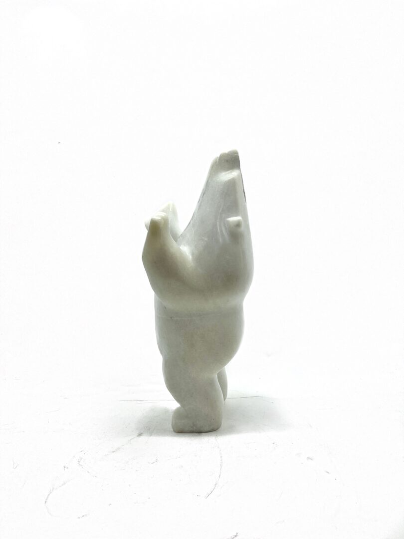 One original hand-carved sculpture by Inuit artist, Joanie Ragee. One dancing bear carved out of white marble.