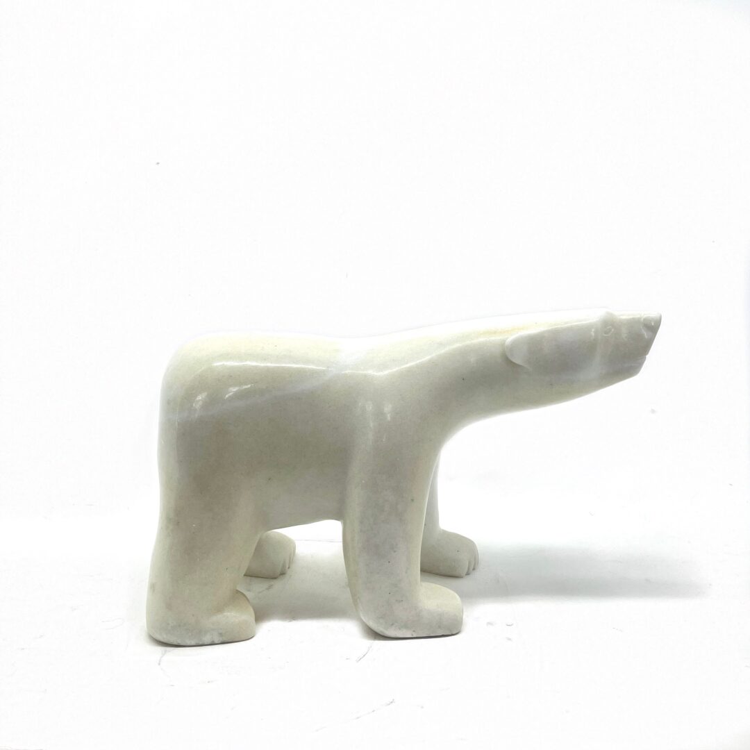 One original hand-carved sculpture by Inuit artist, Adamie Qaumagiaq. One walking bear carved out of white marble.