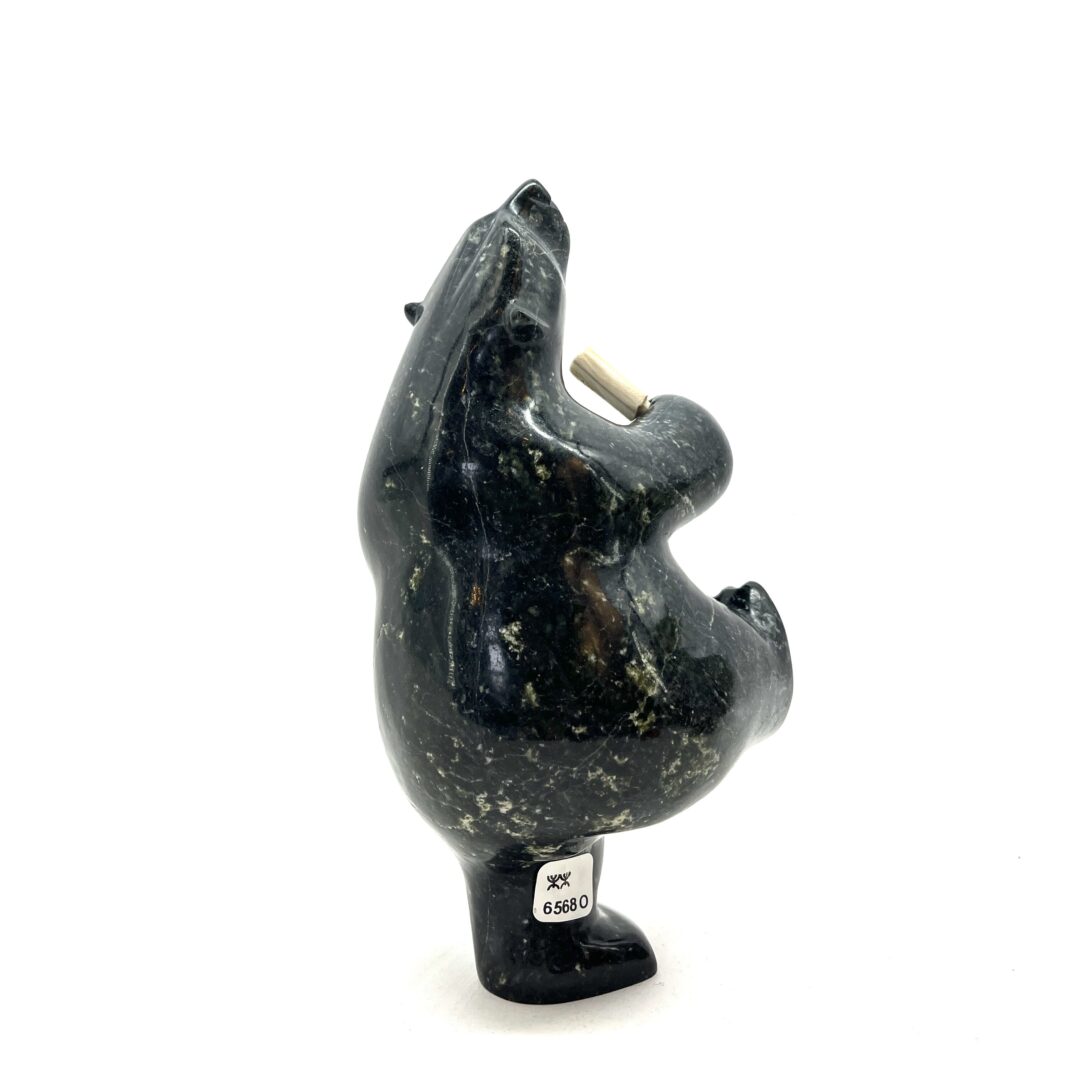 One original hand-carved sculpture by Inuit artist, Etidloie Adla. One drum dancing bear carved out of serpentine.