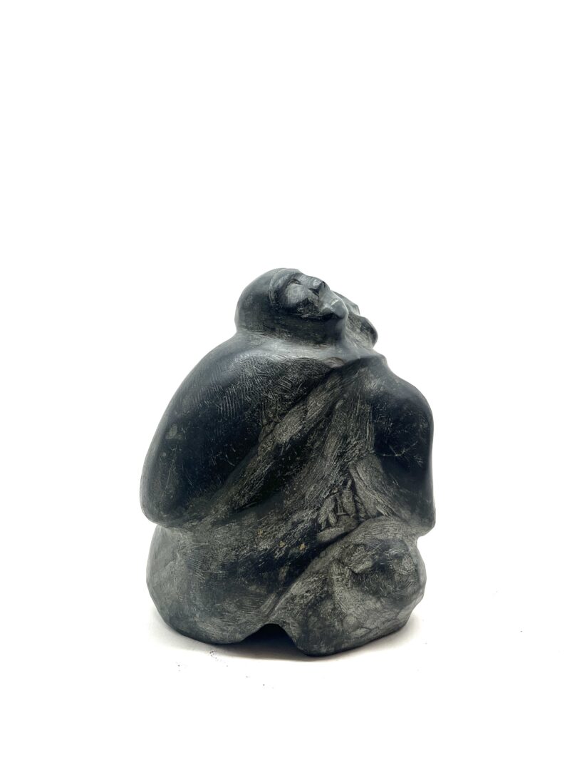 One original hand-carved sculpture by Inuit artist, Barnabus Arnasungaaq. One mother and child carved out of basalt.