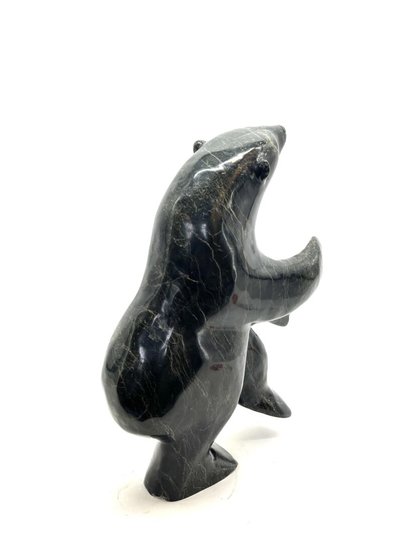 One original hand-carved sculpture by Inuit artist, Nuna Parr. One dancing bear sculpture carved out of serpentine.