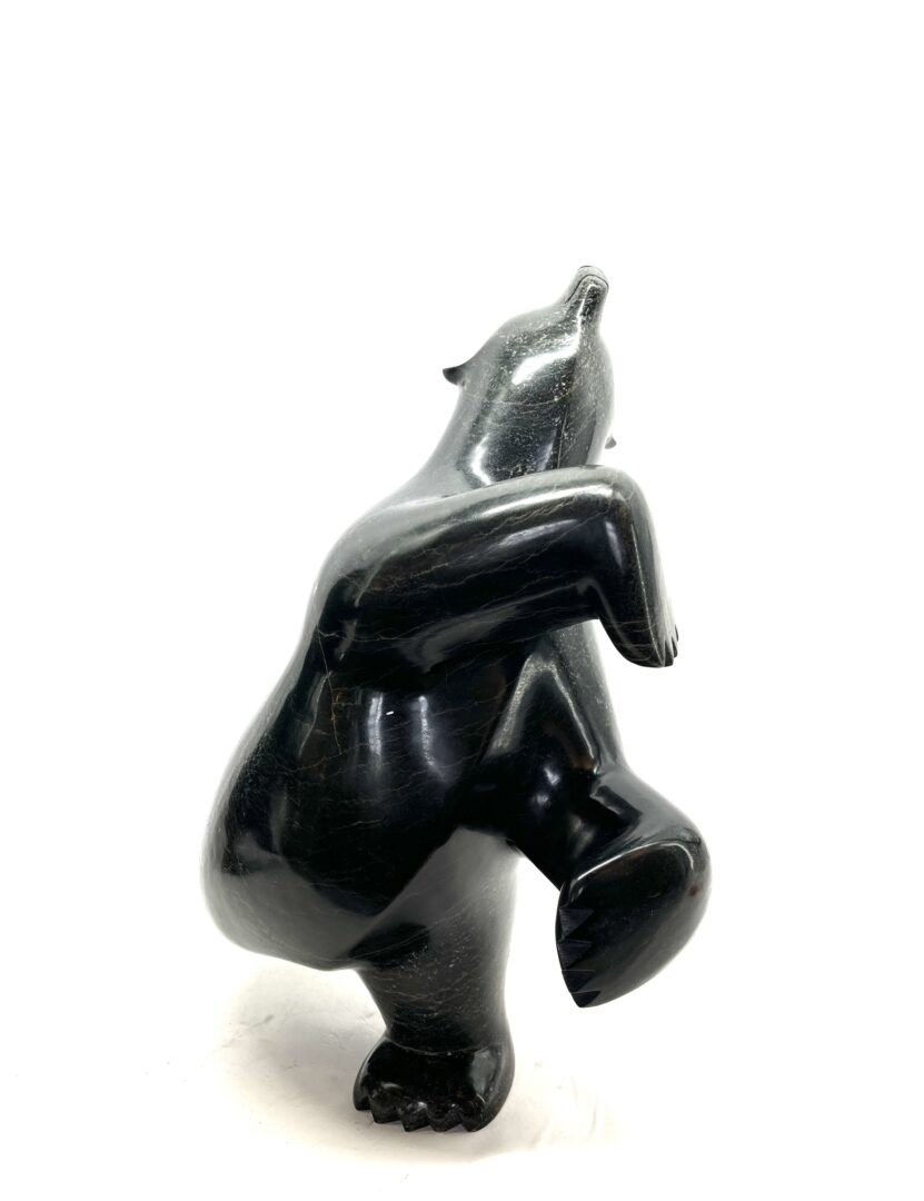 One original hand-carved sculpture by Inuit artist, Ashevak Adla. One dancing bear carved out of serpentine.