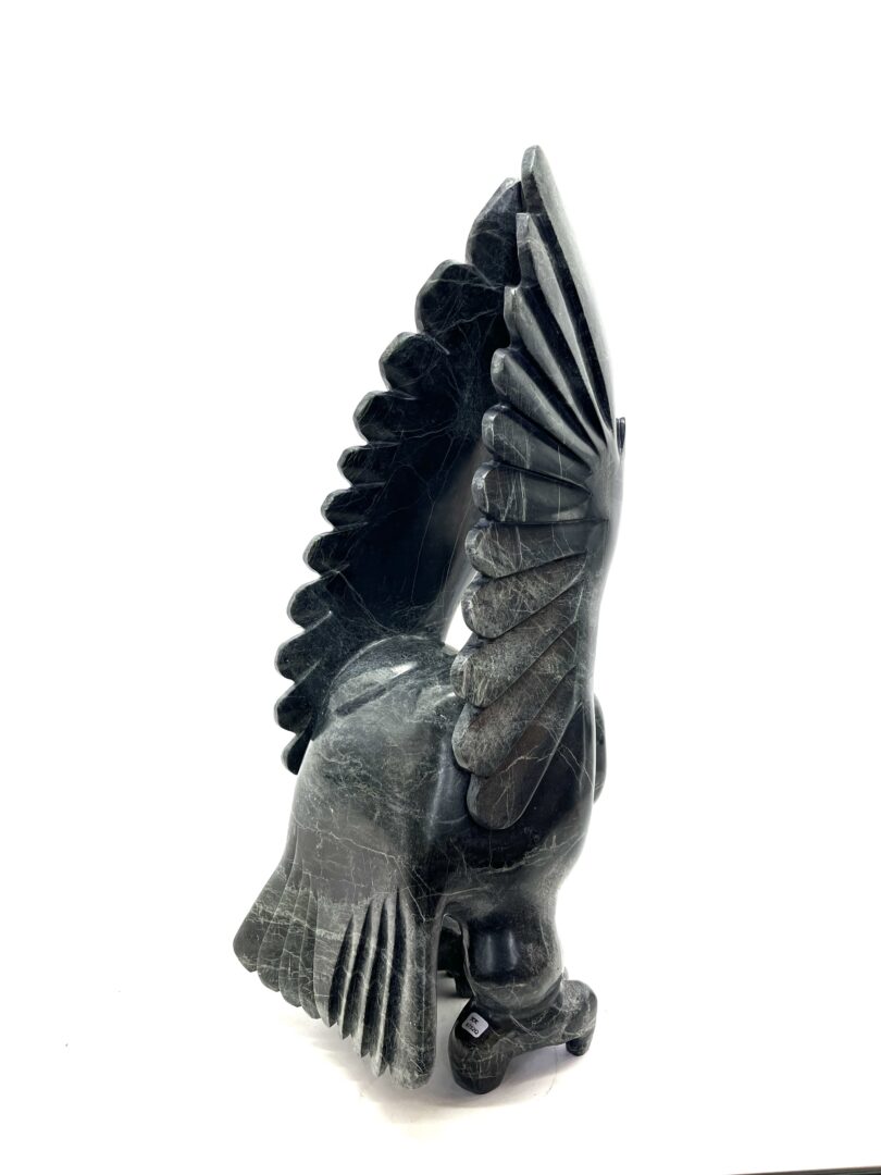 One original hand-carved sculpture by Inuit artist, Toonoo Sharky. One owl sculpture carved out of serpentine.