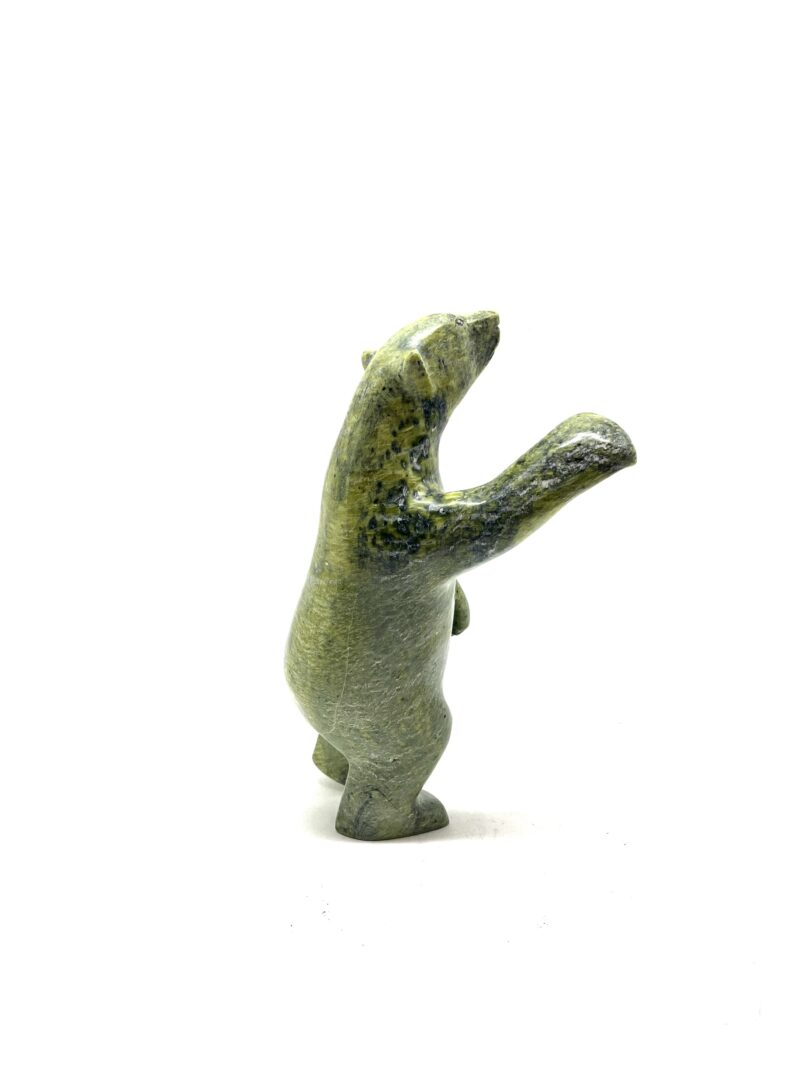 One original hand-carved sculpture by Inuit artist, Kooyoo Peter. One two way bear carved out of serpentine.