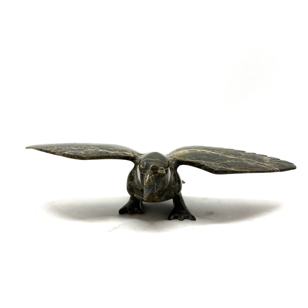 One original hand-carved sculpture by Inuit artist, Napachie Skarky. One flying bird carved out of serpentine.