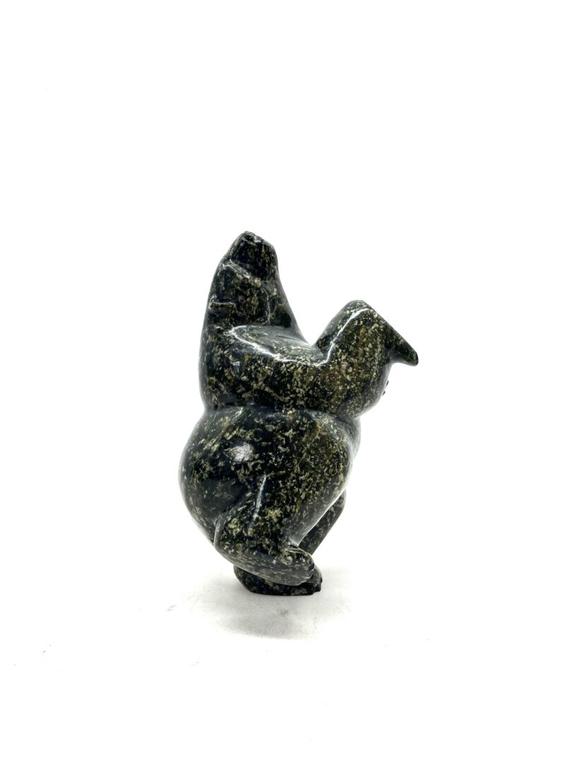 One original hand-carved sculpture by Inuit artist, Isaacie Petaulasse. One three-way dancing bear carved of out serpentine.