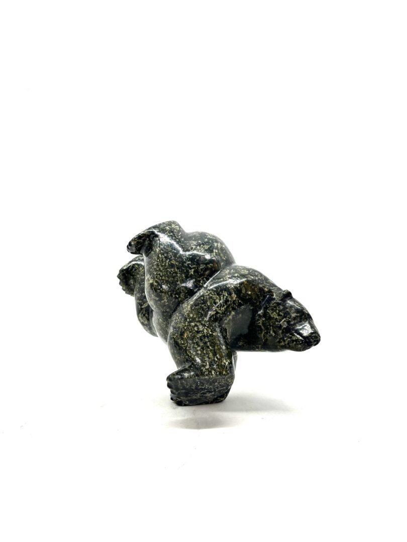 One original hand-carved sculpture by Inuit artist, Isaacie Petaulasse. One three-way dancing bear carved of out serpentine.