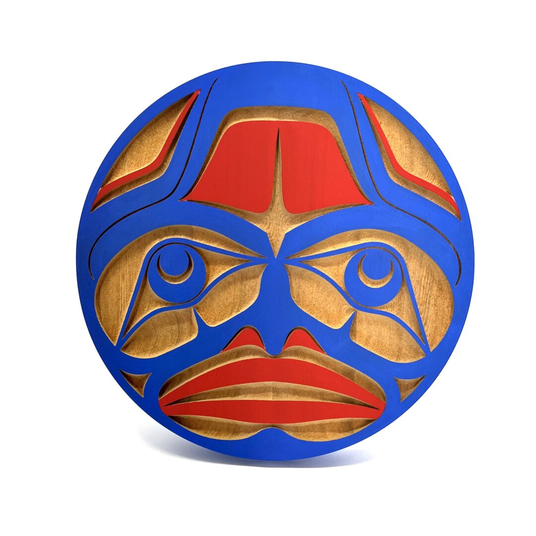 One original hand-carved panel by Nuxalk artist, Nusmata. One sun panel carved out of cedar wood and acrylic paint.