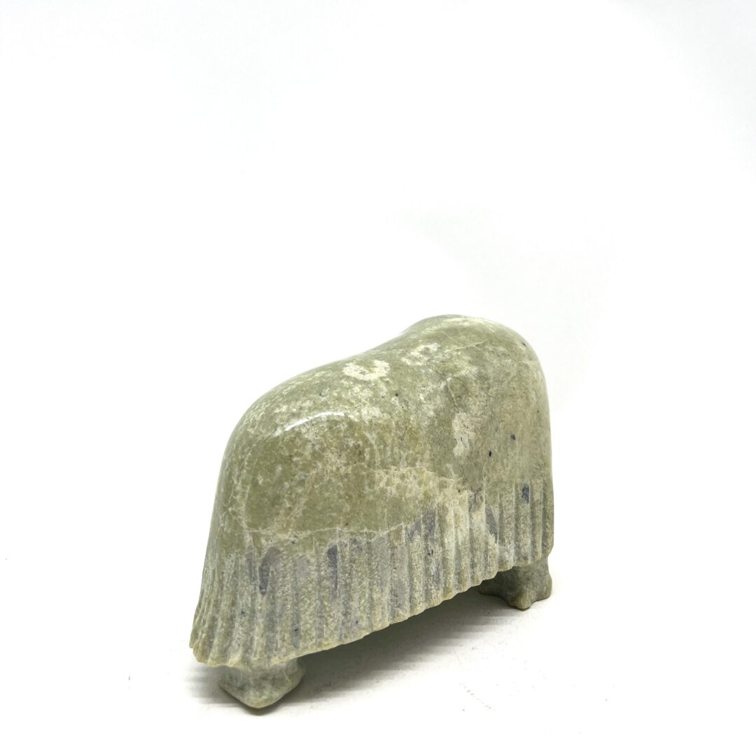 One original hand-carved sculpture by Inuit artist, Willie Kolola. One musk-ox sculpture carved out of serpentine.