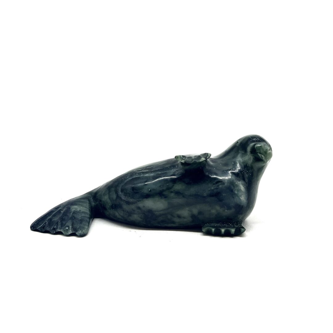 One original hand-carved sculpture by Inuit artist, Willie Kolola. One seal sculpture carved out of serpentine.