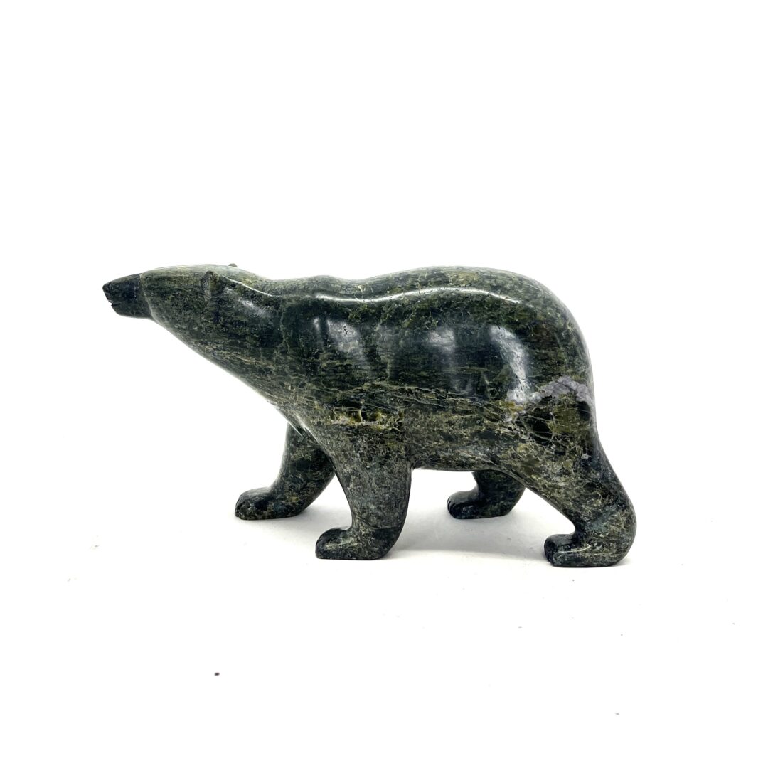 One original hand-carved sculpture by Inuit artist, Tim Pee. One walking bear sculpture carved out of serpentine.
