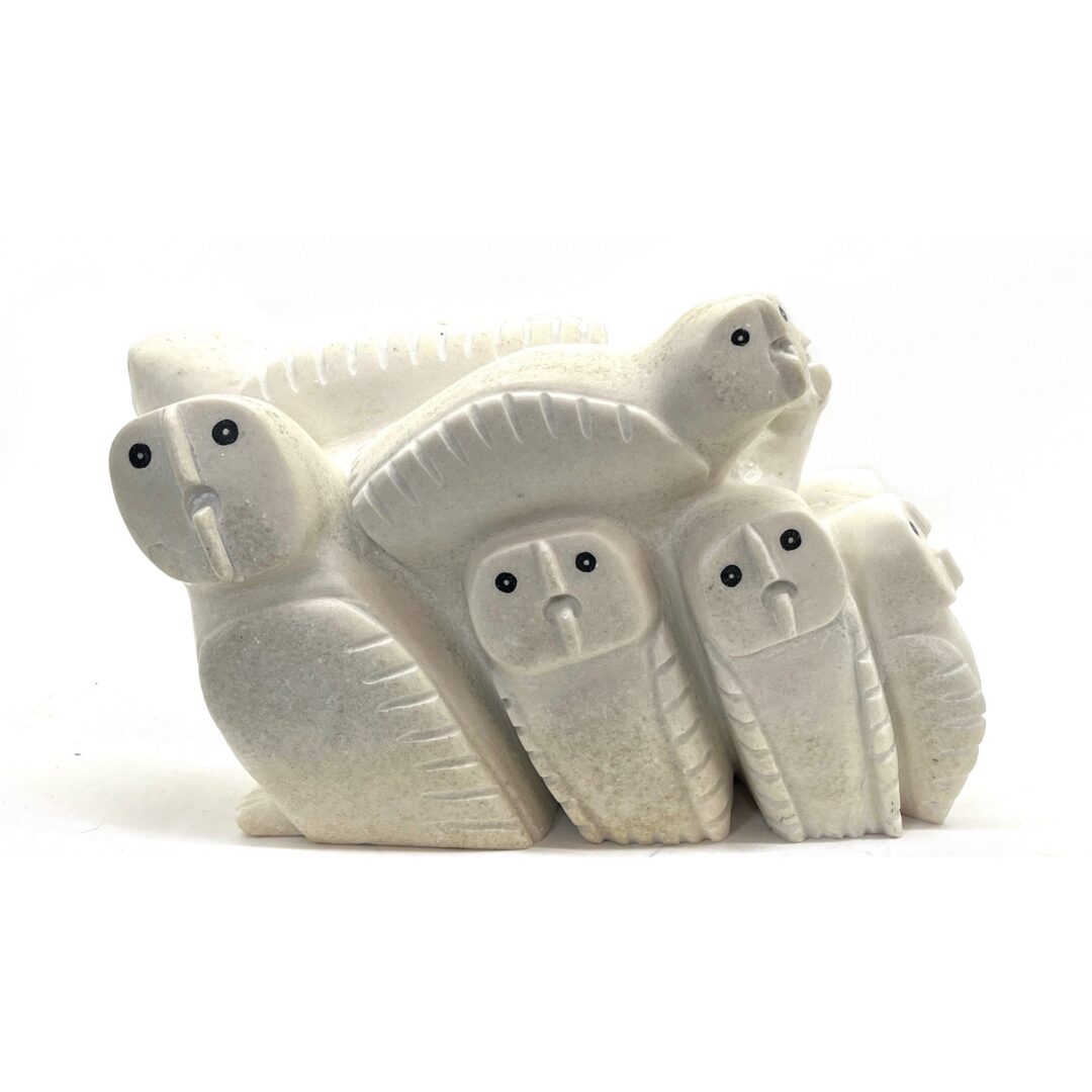 One original hand-carved sculpture by Inuit artist, Palaya Qiatsuk. Ten owls in one carved in white marble.
