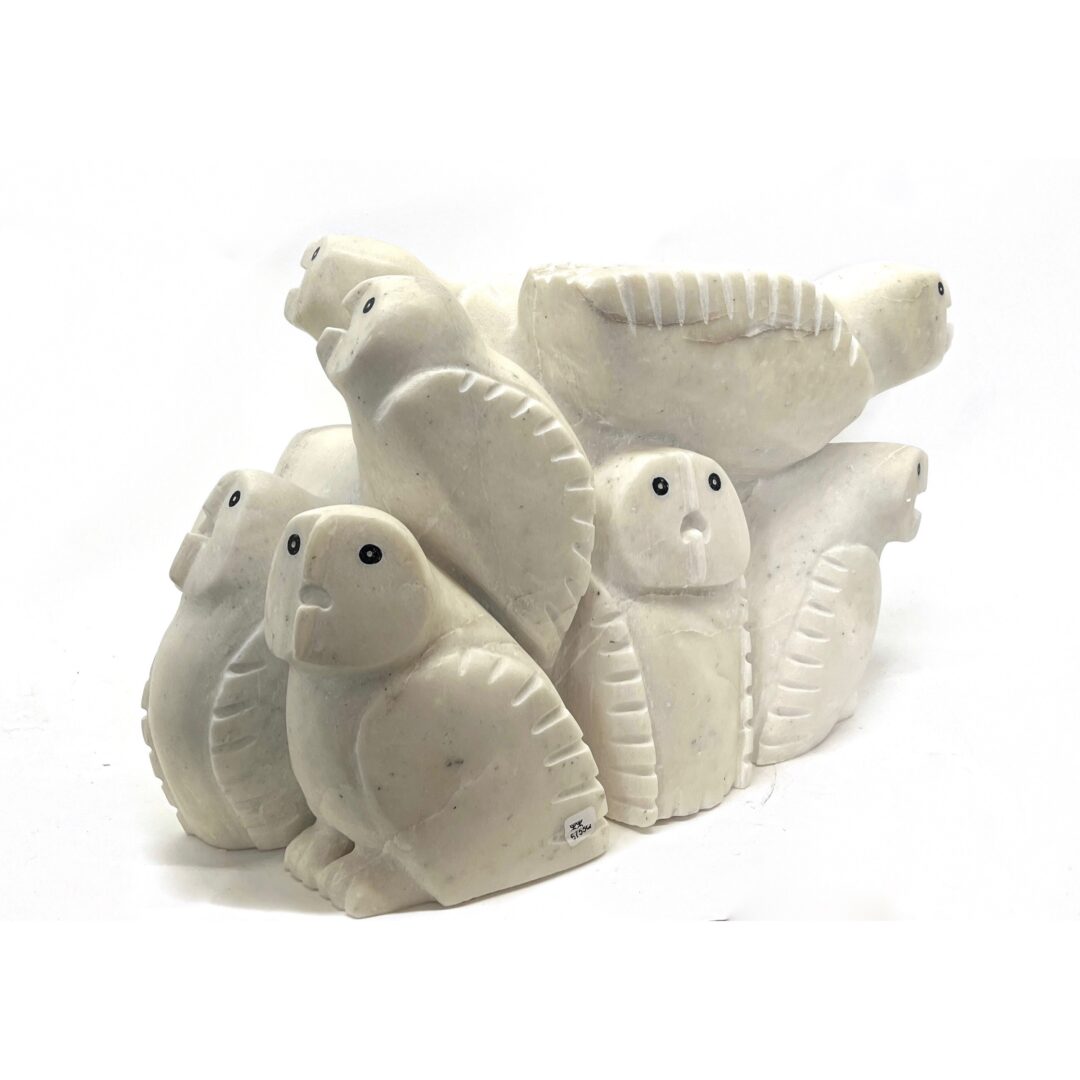 One original hand-carved sculpture by Inuit artist, Palaya Qiatsuk. Ten owls in one carved in white marble.