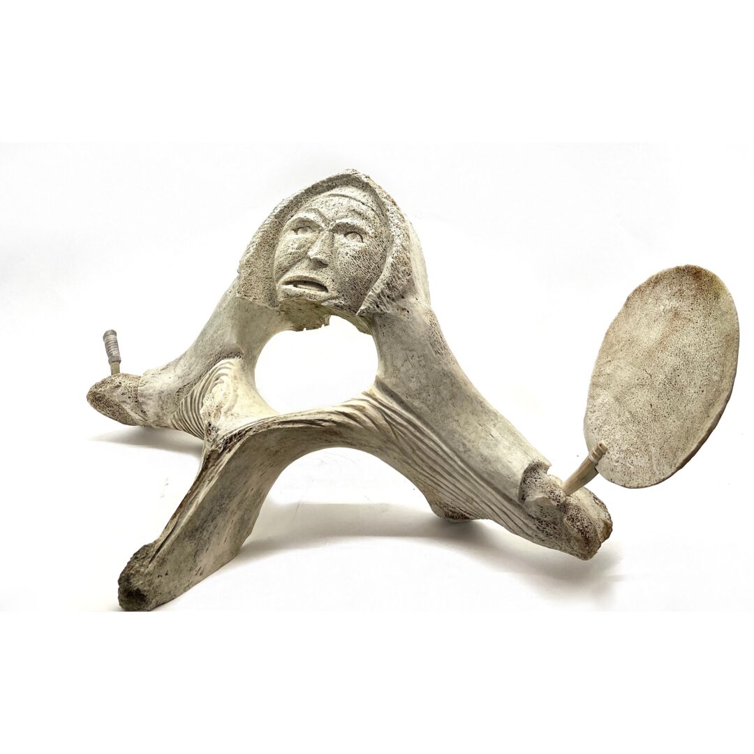 One original hand-carved sculpture by Inuit artist Jaco Ishulutak. One drum dancer carved out of fossilized whale bone.