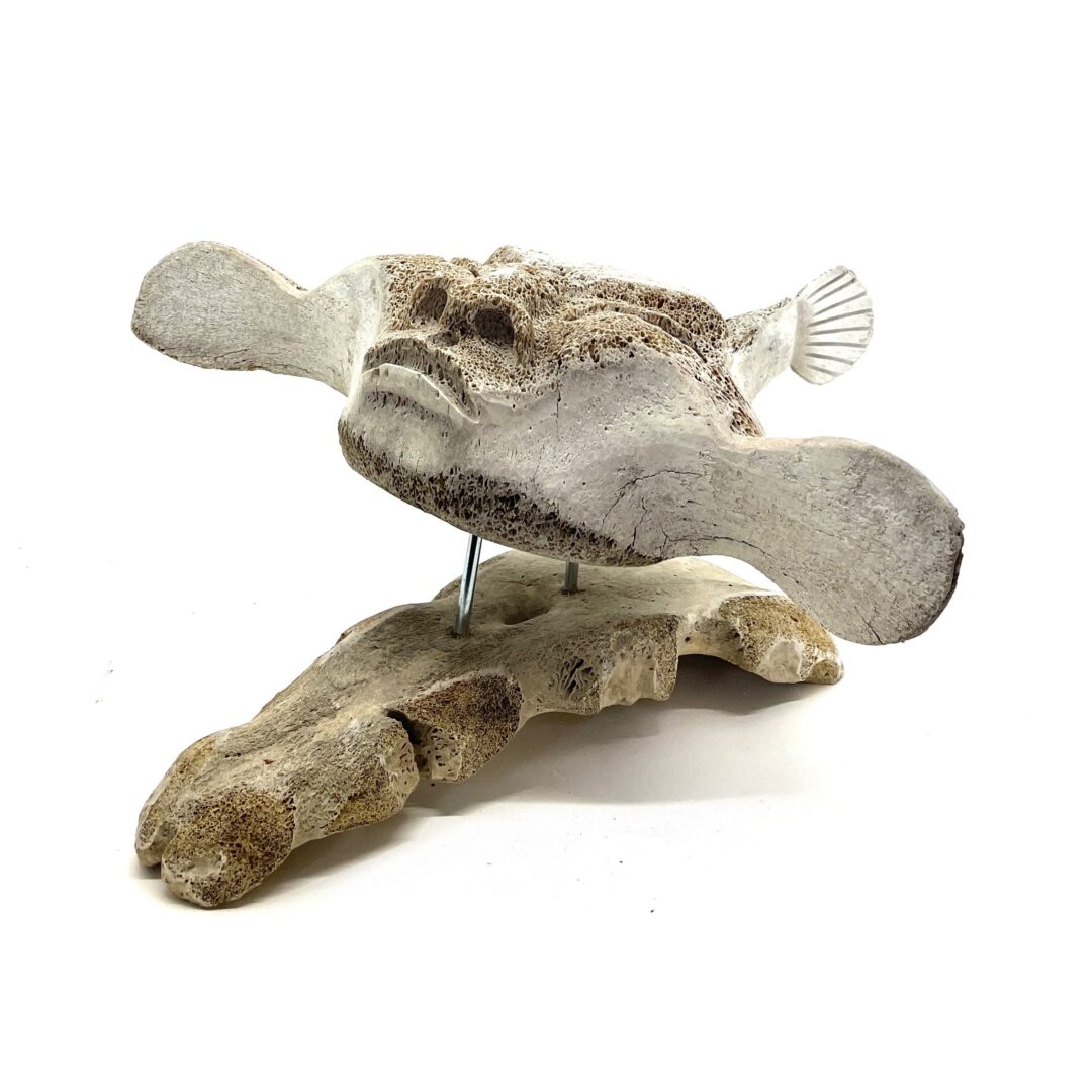 One original hand-carved sculpture by Inuit artist, Billy Merkosak. One shaman carved out of fossilized whale bone.