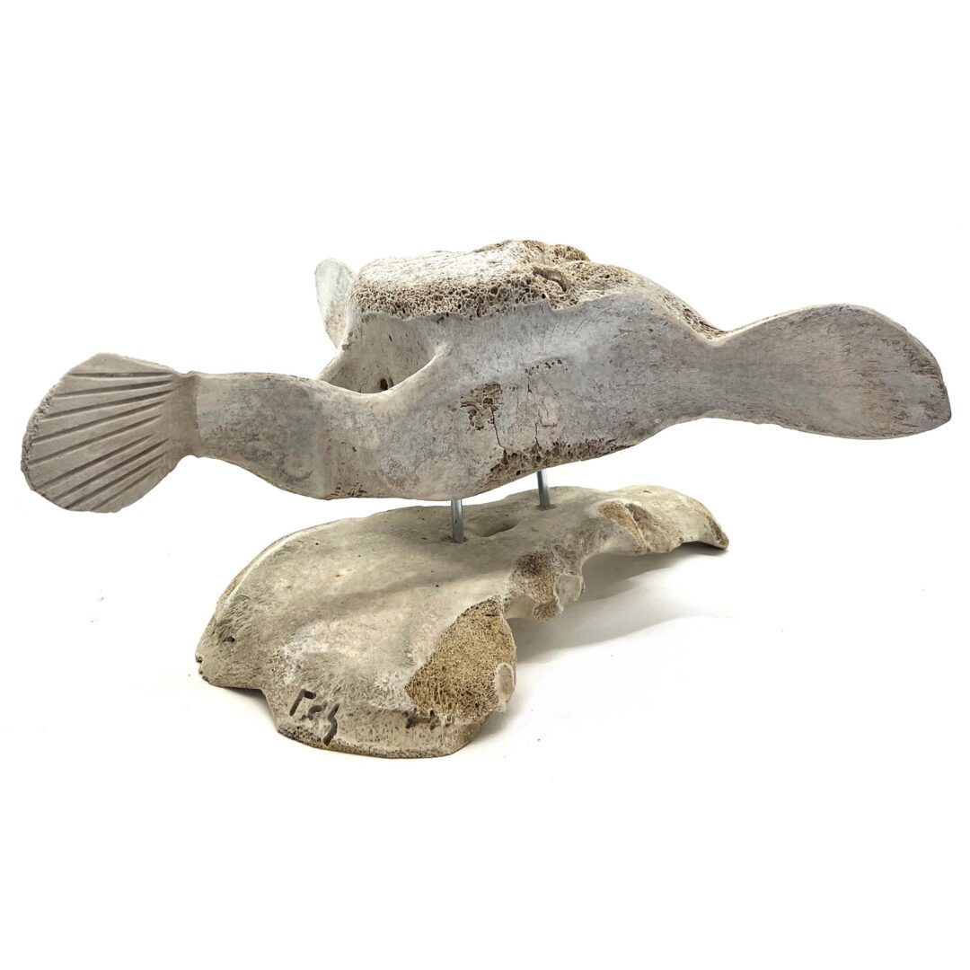One original hand-carved sculpture by Inuit artist, Billy Merkosak. One shaman carved out of fossilized whale bone.