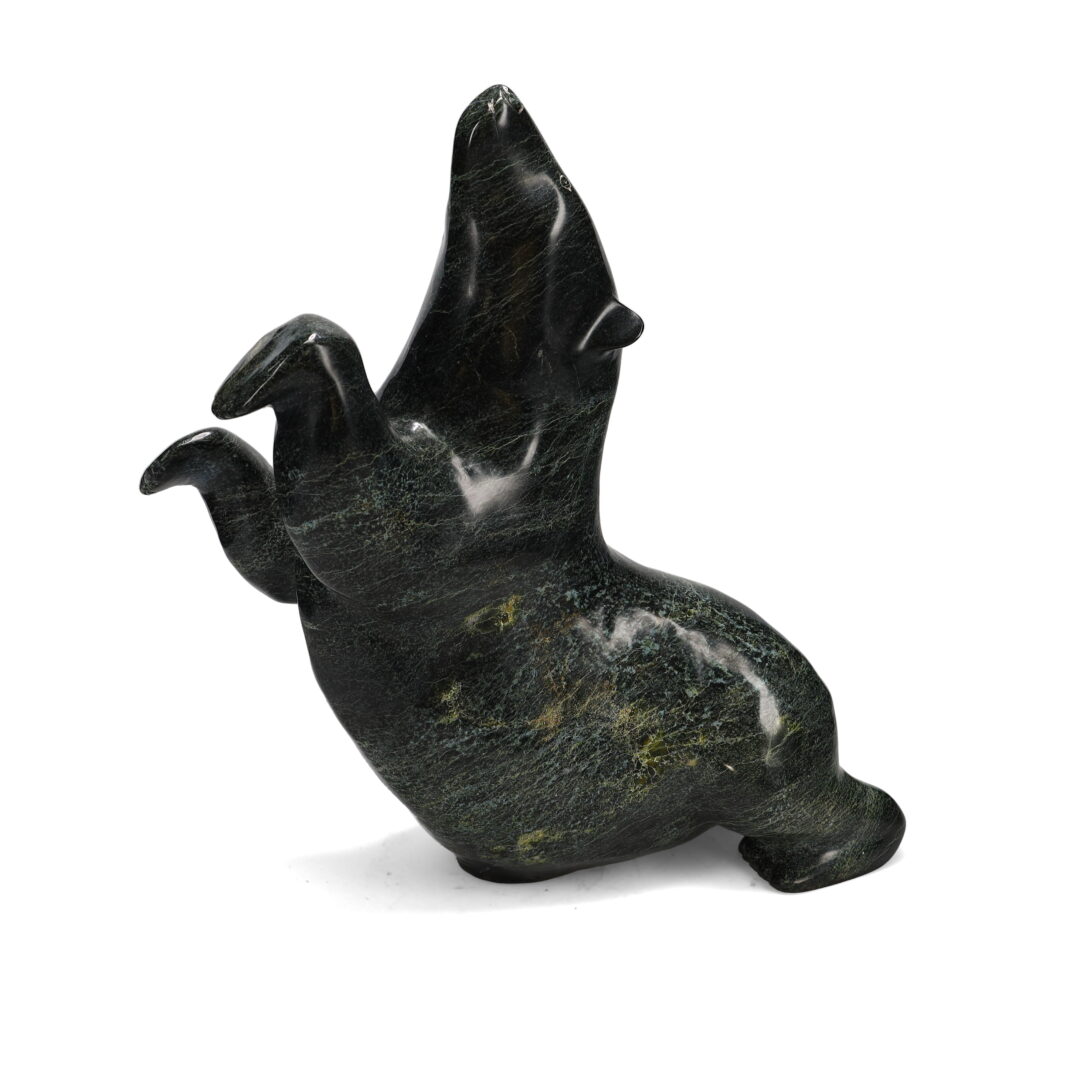 One original hand-carved sculpture by Inuit artist Nuna Parr. One bear on its belly carved out of serpentine.