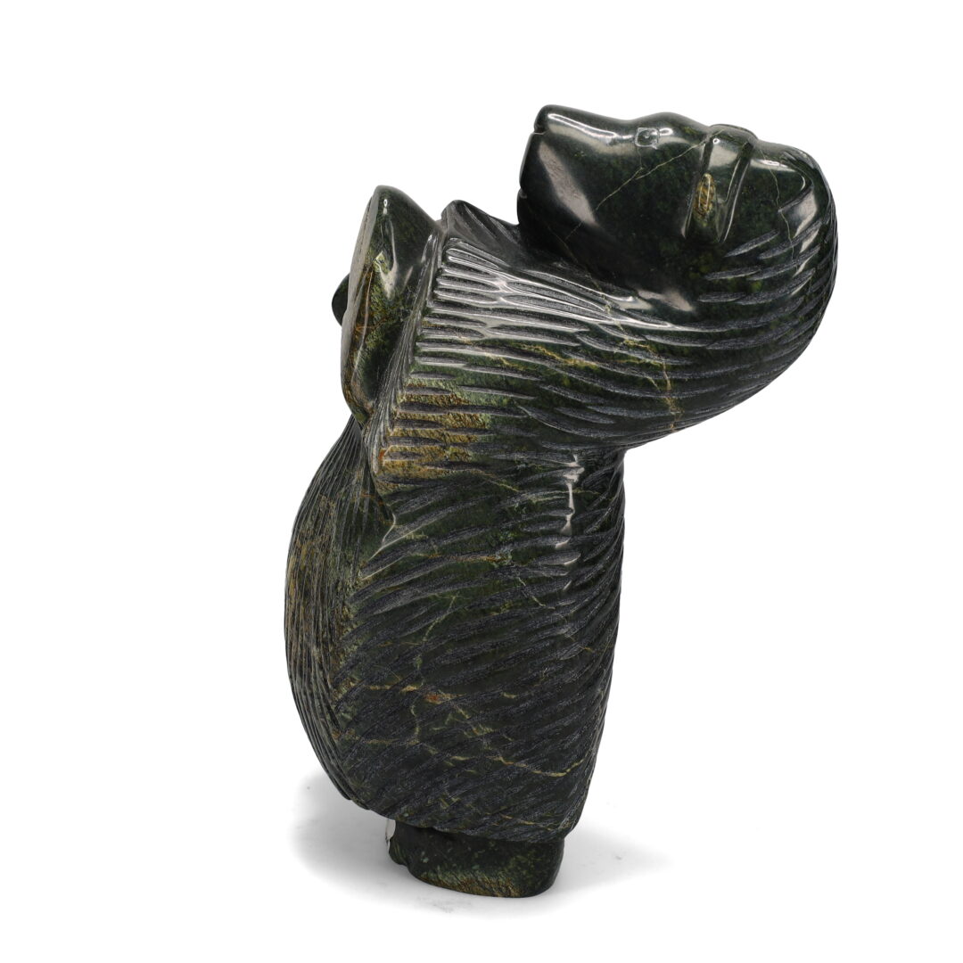 One original hand-carved sculpture by Inuit artist Pitsulak Qimirpik. One dancing muskox carved out of serpentine.