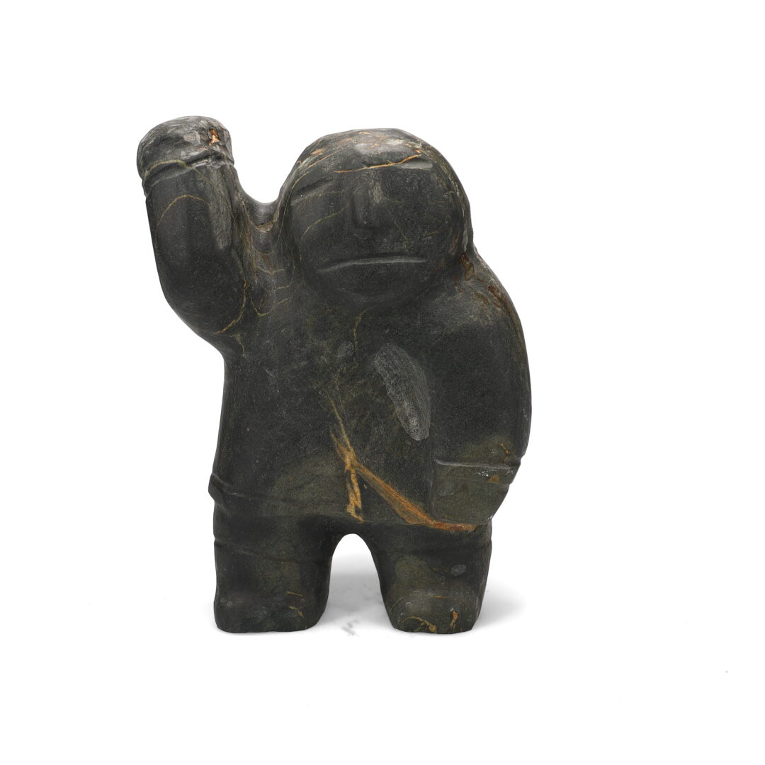 One original hand-carved sculpture by Inuit artist David Iqutaaq. One Inuk with raised arm carved out of basalt stone.