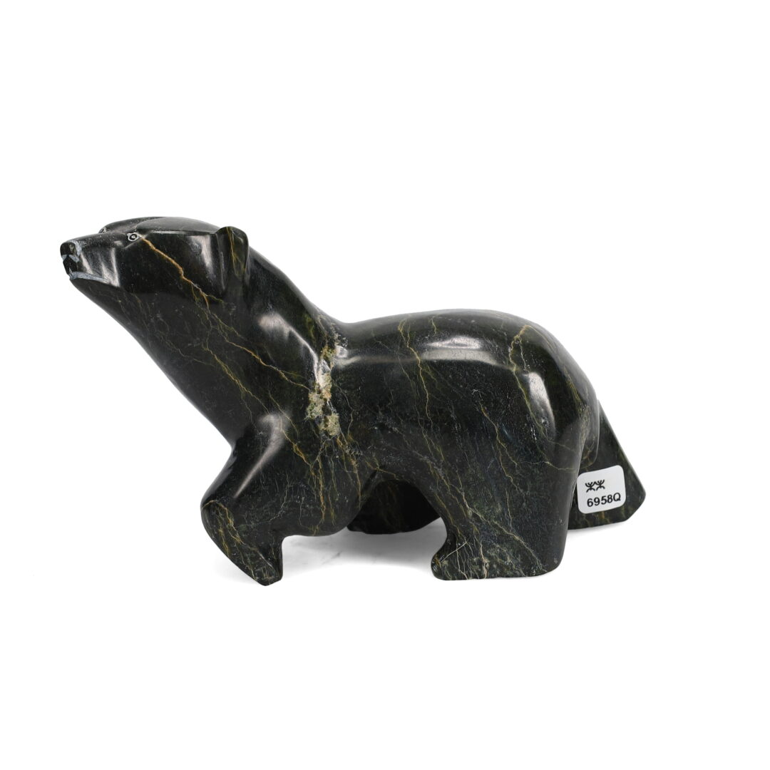 One original hand-carved sculpture by Inuit artist Malito Akesuk. One walking bear carved out of serpentine.