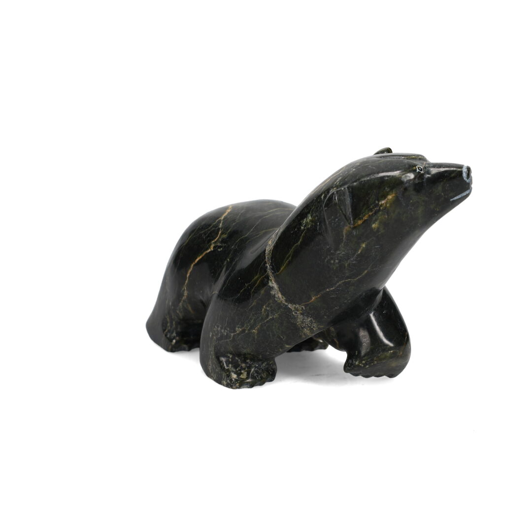 One original hand-carved sculpture by Inuit artist Malito Akesuk. One walking bear carved out of serpentine.