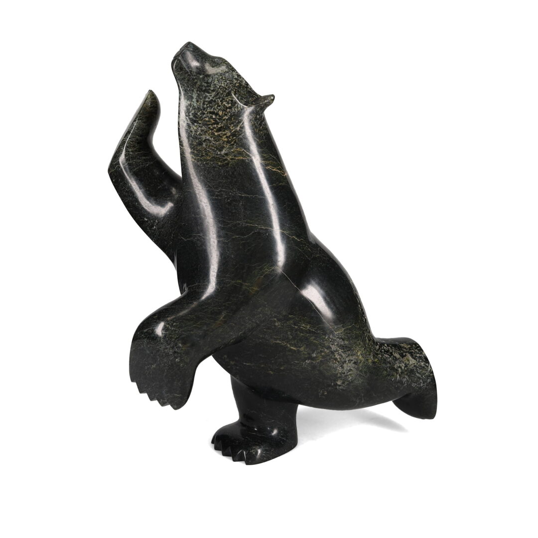 One original hand-carved sculpture by Inuit artist Ashevak Adla. One dancing bear carved out of serpentine.