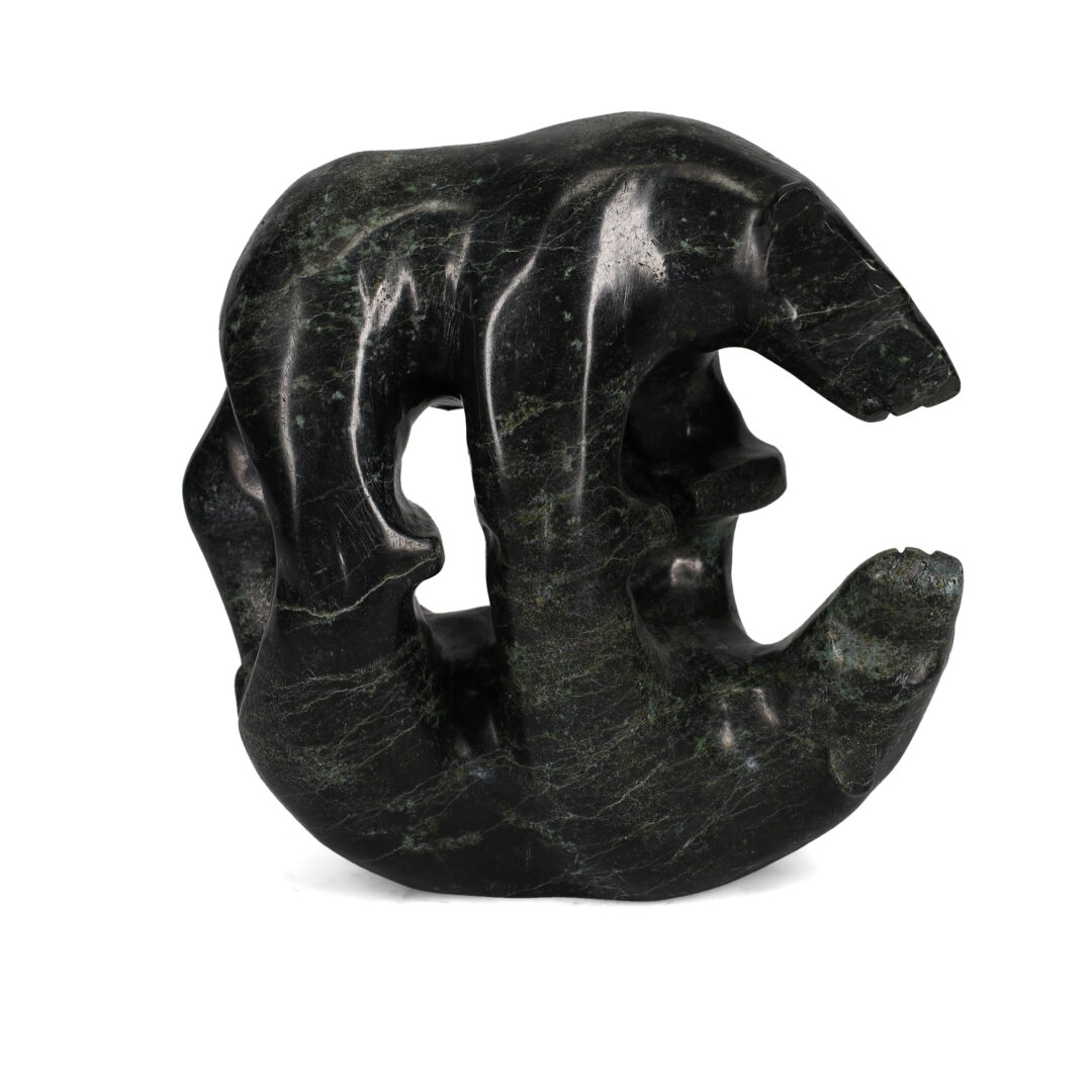 One original hand-carved sculpture by Inuit artist Tony Oqutaq. One bear reflection carved out of serpentine.