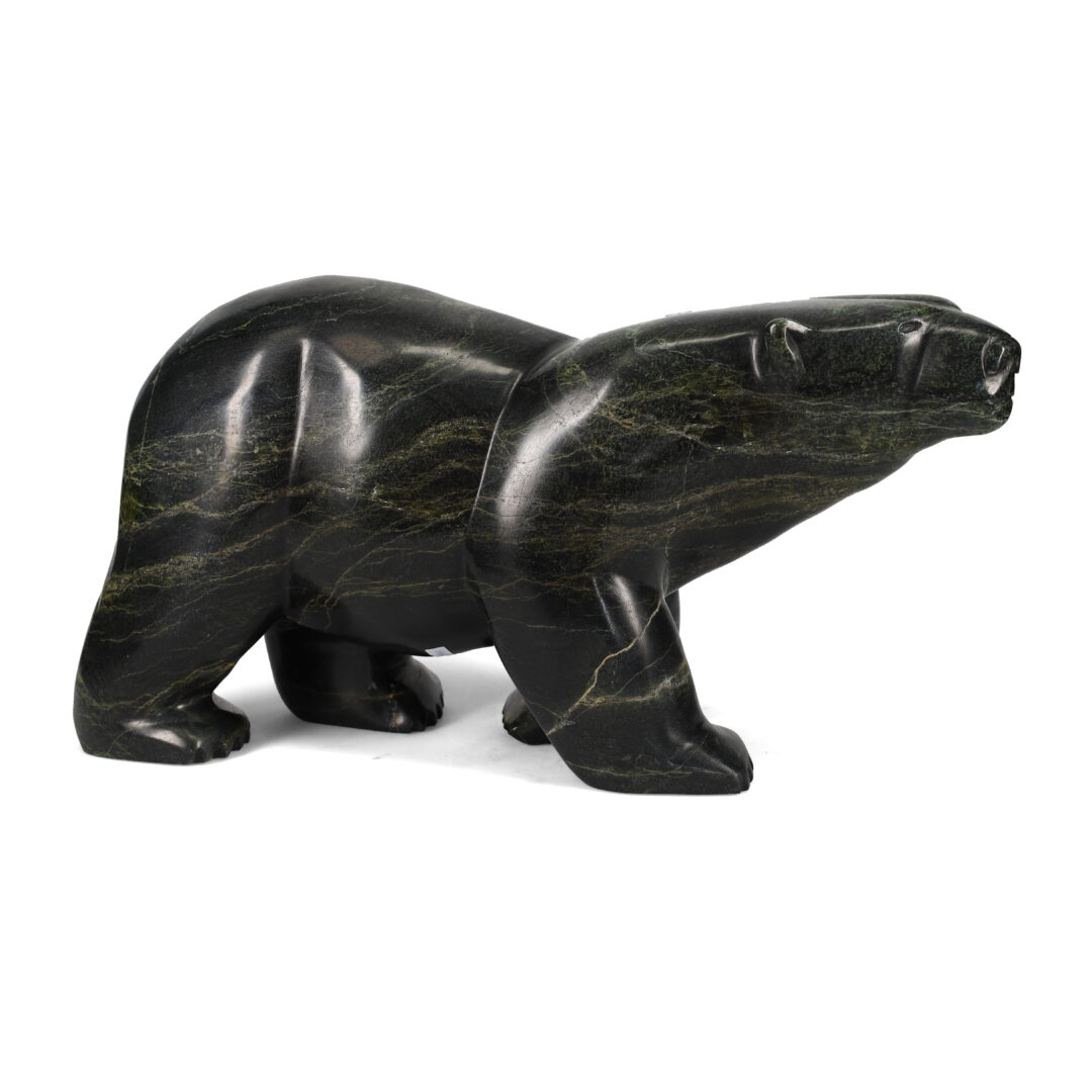 One original hand-carved sculpture by Inuit artist Isaaci Petaulassie. One walking bear carved out of serpentine.