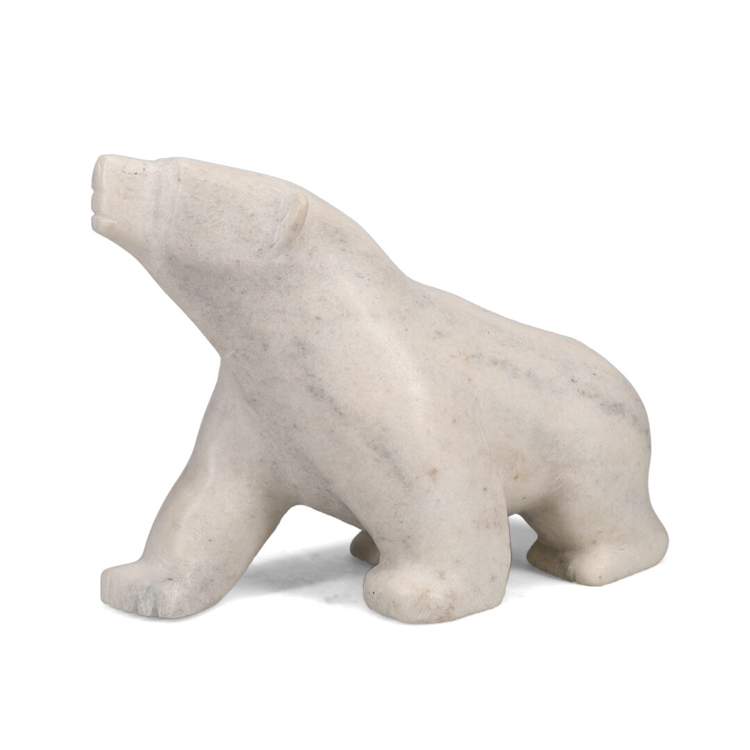 One original hand-carved sculpture by Inuit artist Ottokie Ashoona. One walking bear carved out of white marble.