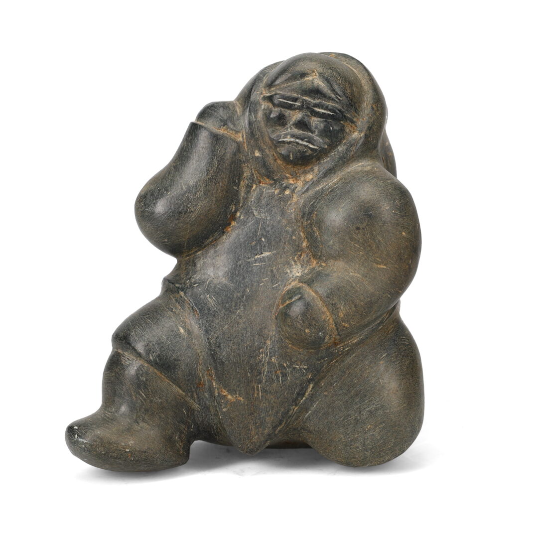 One original hand-carved sculpture by Inuit artist Barnabus. One inuk with goggles carved out of basalt stone.
