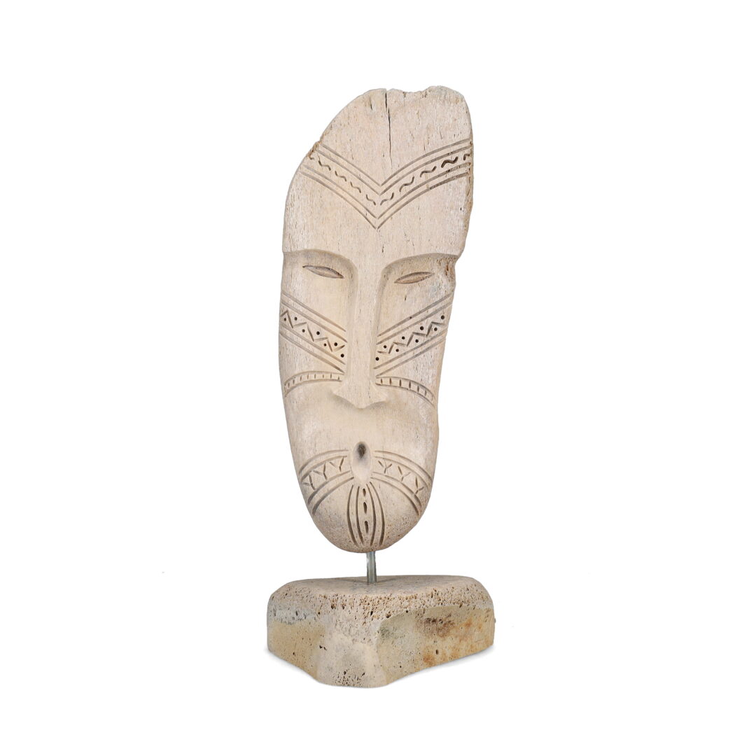 One original hand-carved sculpture by Inuit artist, Billy Merkosak. One Inuk face carved out of fossilized whalebone