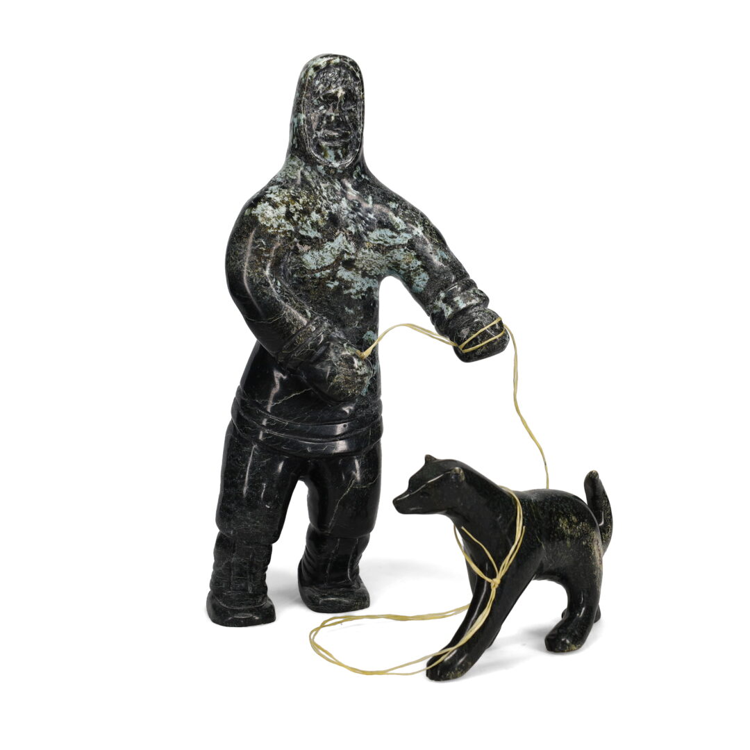 One original hand-carved sculpture by Inuit artist, Kelly Etidloie. One boy and his dog carved out of serpentine.