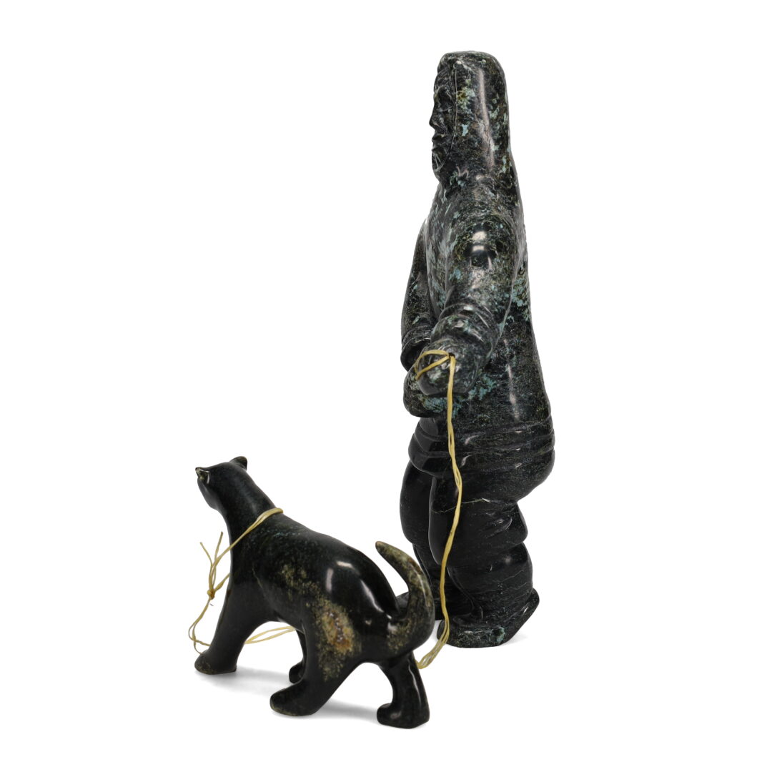 One original hand-carved sculpture by Inuit artist, Kelly Etidloie. One boy and his dog carved out of serpentine.