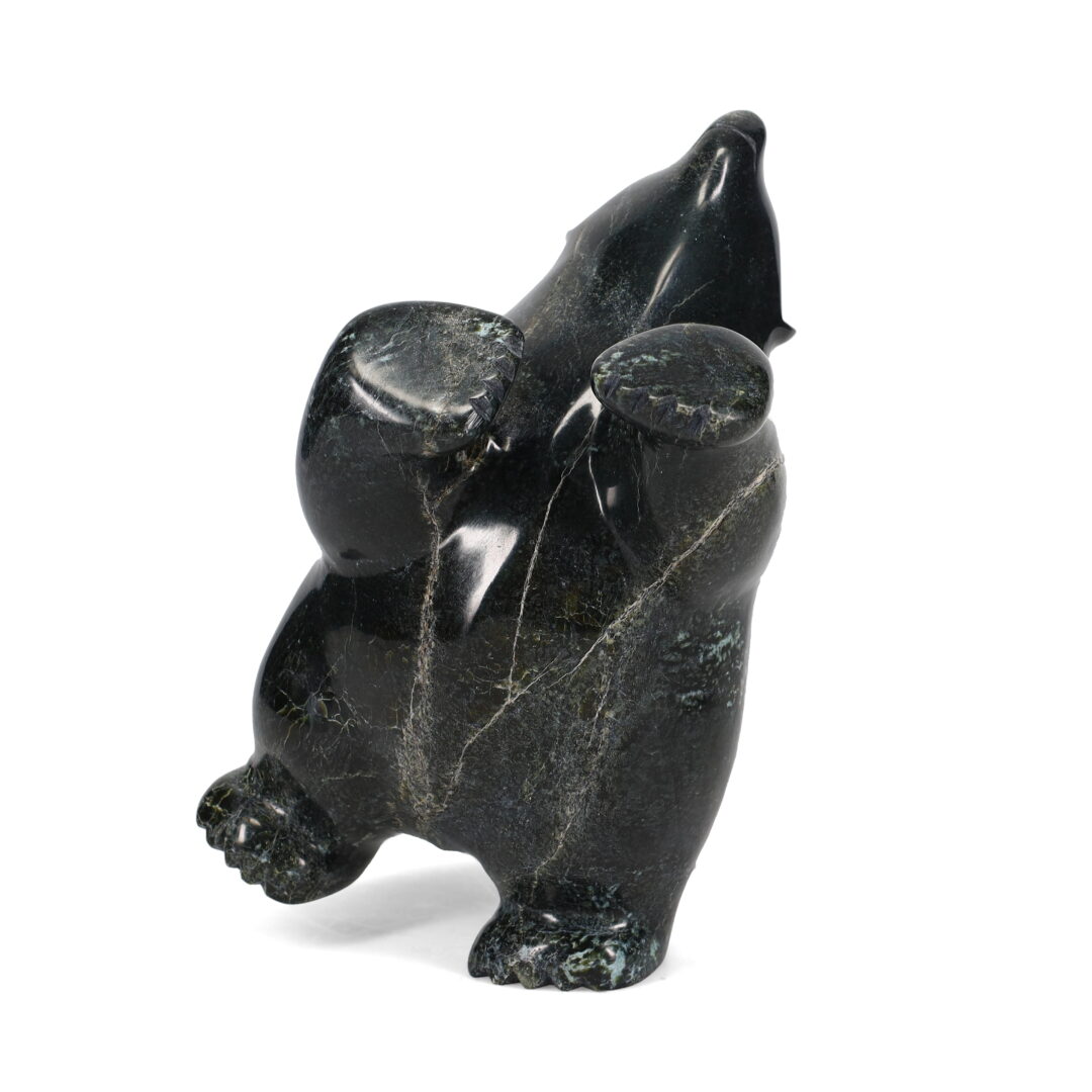 One original hand-carved sculpture by Inuit artist, Etidloie Adla. One dancingg bear carved out of serpentine.