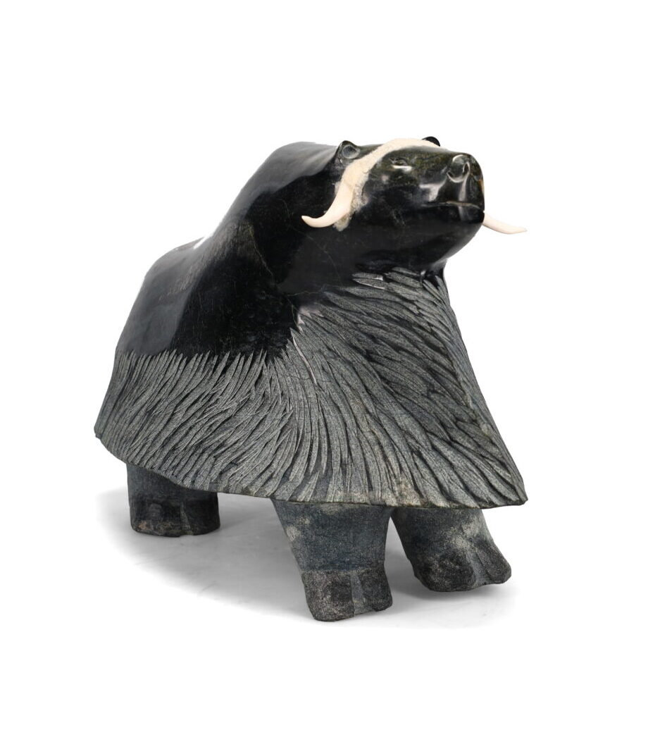 One original hand-carved sculpture by Inuit artist, Kelly Etidloie. One musk-ox carved out of serpentine and antler.