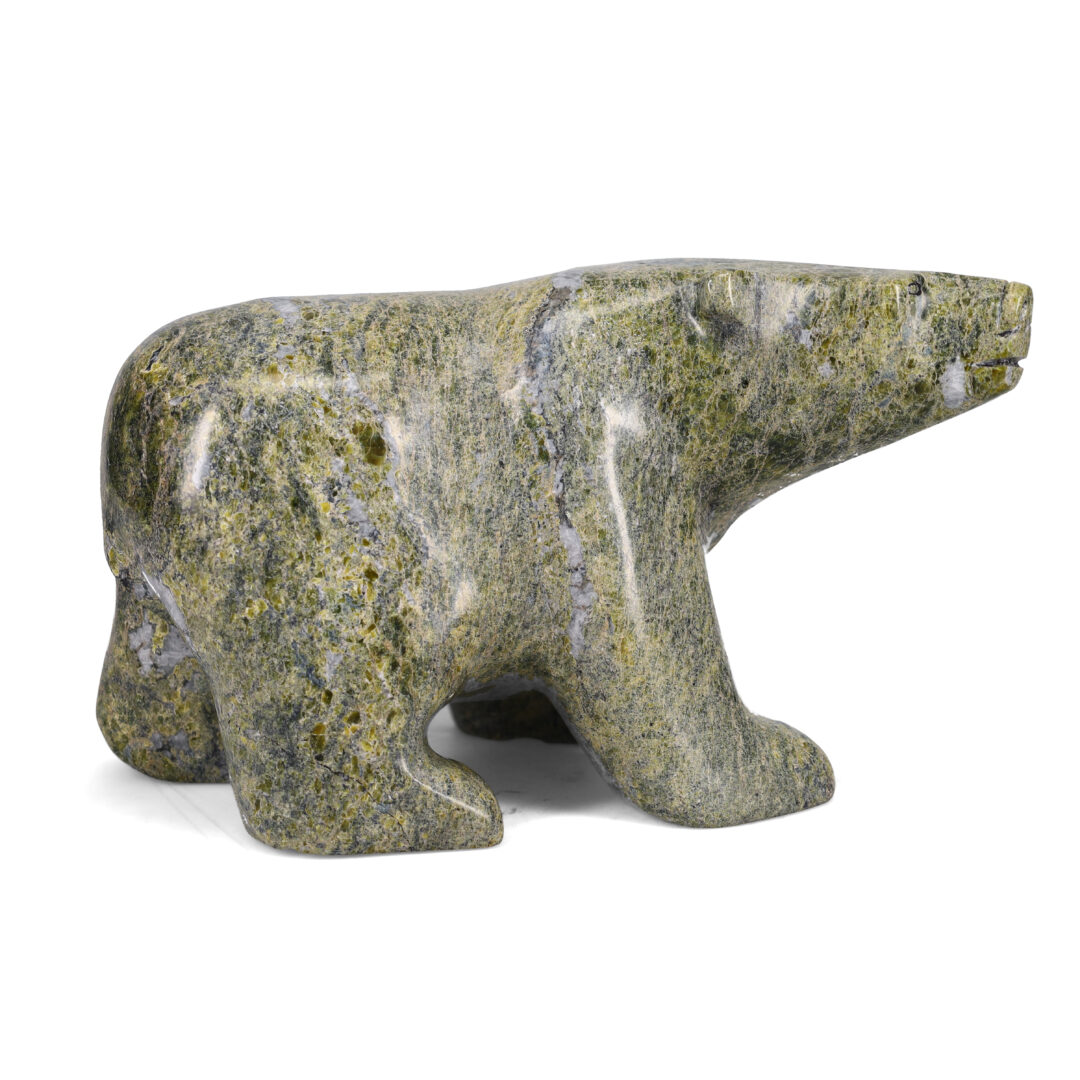 One original hand-carved sculpture by Inuit artist, Joanie Ragee. One walking bear carved out of serpentine.