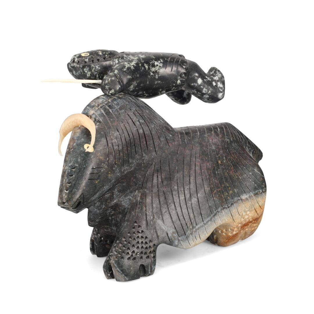 One original hand-carved sculpture by Inuit artist, Andrew Palongayak. One hunter thrown by a muskox carved out of basalt.