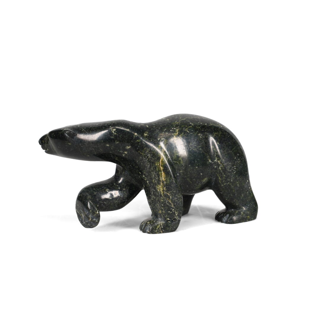 One original hand-carved sculpture by Inuit artist, Quaraq Nungisuituk. One walking bear carved out of serpentine.