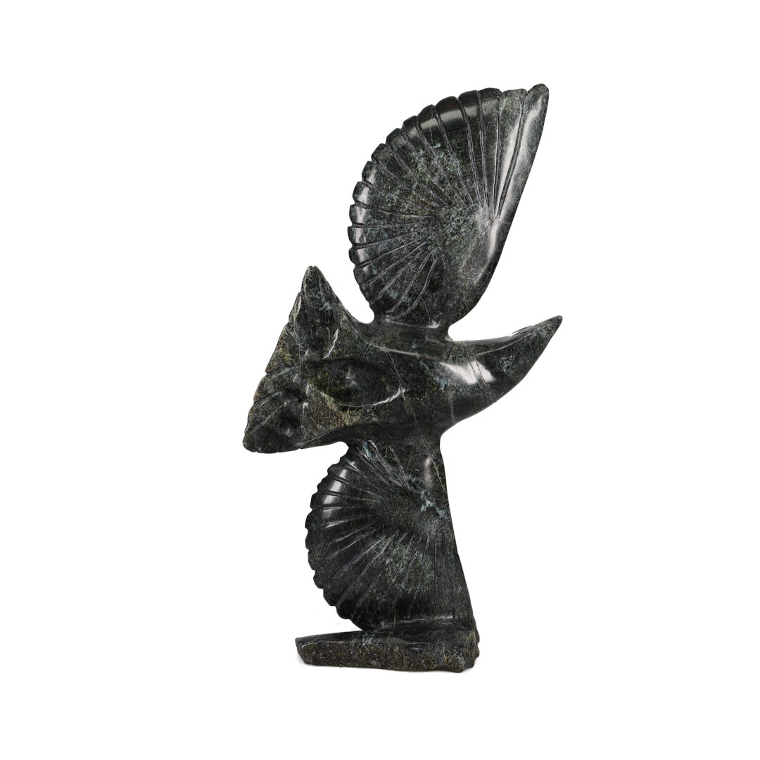 One original hand-carved sculpture by Inuit artist, Kelly Etidloie. One bird in flight carved out of serpentine.