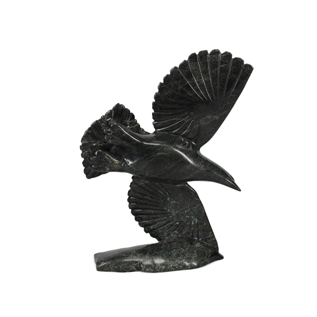 One original hand-carved sculpture by Inuit artist, Kelly Etidloie. One bird in flight carved out of serpentine.