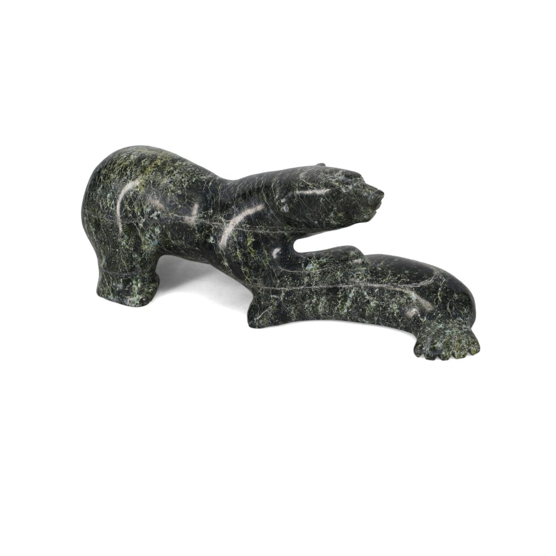 One original hand-carved sculpture by Inuit artist, Ashoona Ashoona. One bear with fish carved out of serpentine.