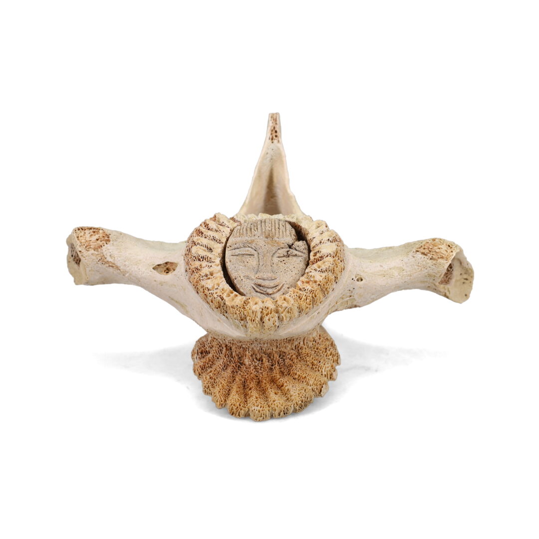 One original hand-carved sculpture by Inuit artist, Alex Kayotak. One fave carved onto a fossilized whale vertebra.