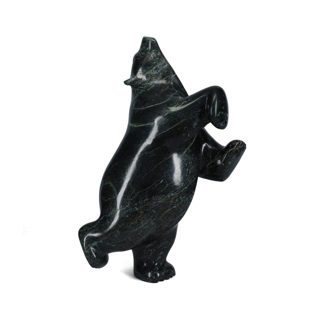 One original hand-carved sculpture by Inuit artist, Etidloie Adla. One dancing bear carved out of serpentine.