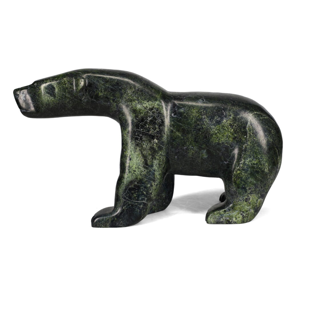 One original hand-carved sculpture by Inuit artist, Ashevak Tunillie. One walking bear carved out of serpentine.