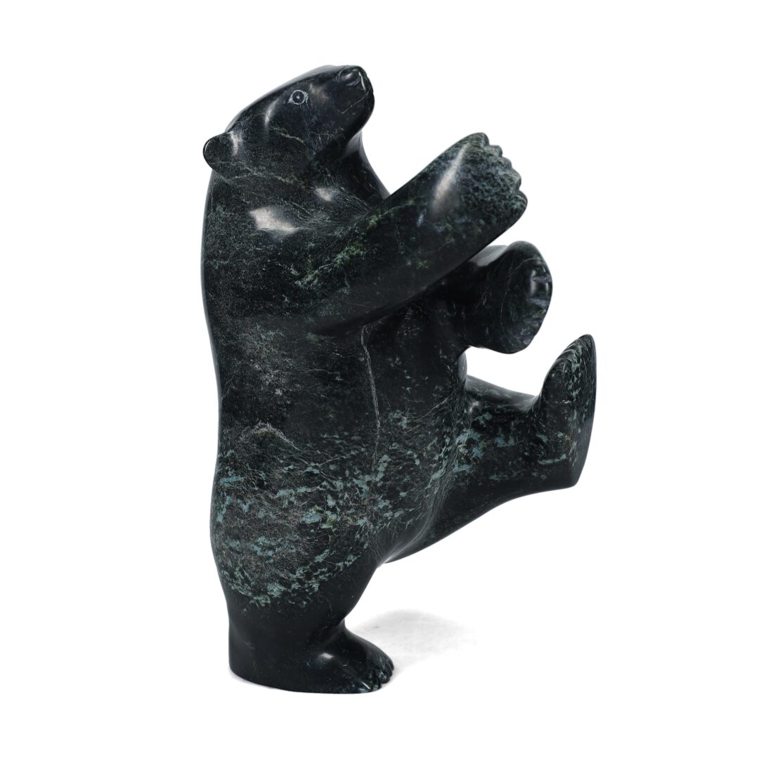 One original hand-carved sculpture by Inuit artist, Nuna Parr. One dancing bear carved out of serpentine stone.