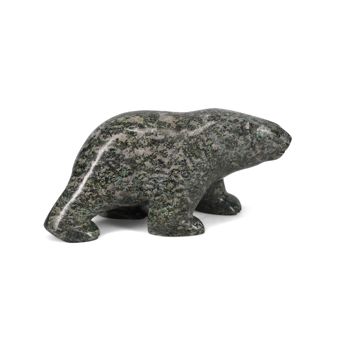 One original hand-carved sculpture by Inuit artist, Etidloie Adla. One walking bear carved out of serpentine.