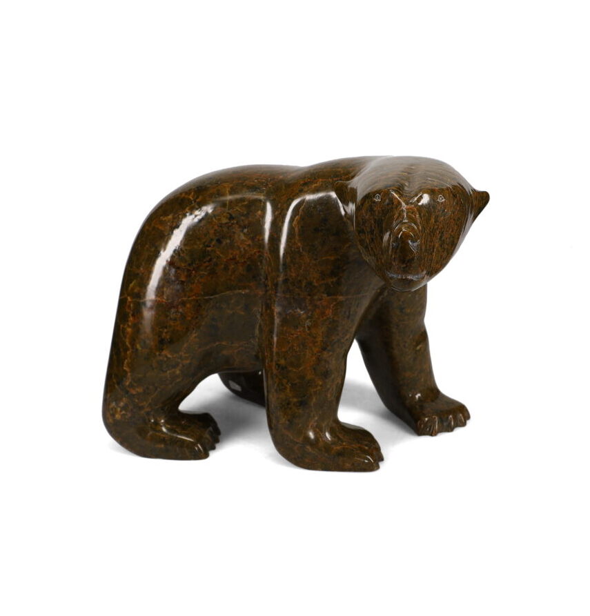 One original hand-carved sculpture by Inuit artist, Ashevak Tunnillie. One walking bear carved out of serpentine.